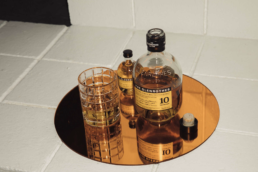 the glenroths bottle next to a cup and smaller bottle