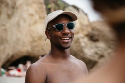 male wearing sunglasses while smiling